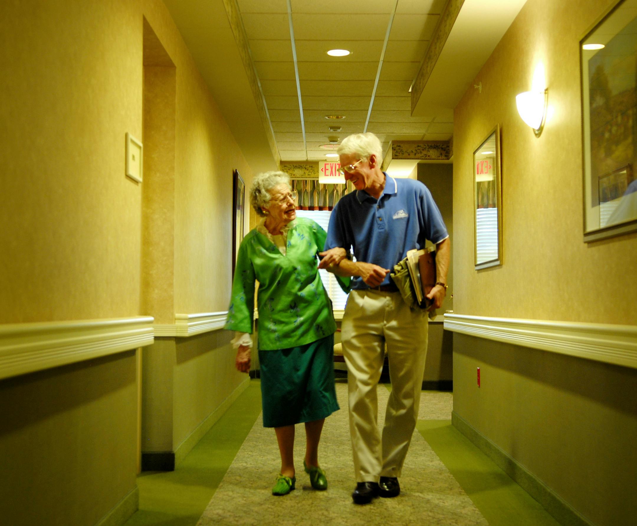 GLEN STUBBE Ô gstubbe@startribune.com Wednesday, May 24, 2006 Ò Bloomington, Minn. Ò Money manager Chuck Bergner walks client Edna Landmesser, 98, through the hallways of her retirement home Friendship Village in Bloomington, as they headed toward his car to go out to dinner.