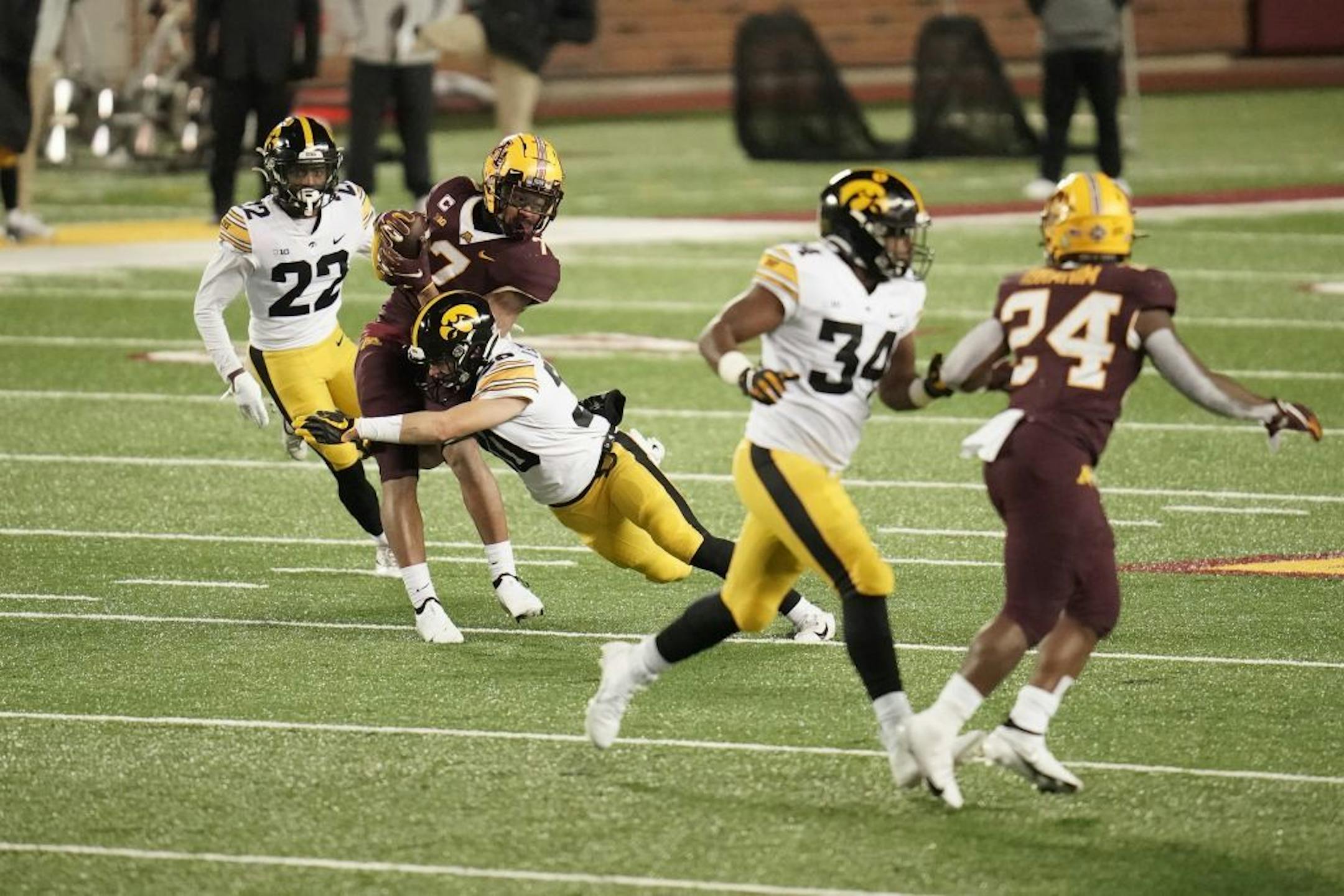 Iowa Hawkeyes defensive back Quinn Schulte (30) tackled Minnesota Gophers wide receiver Chris Autman-Bell (7) who caught a pass for a first down in the fourth quarter.