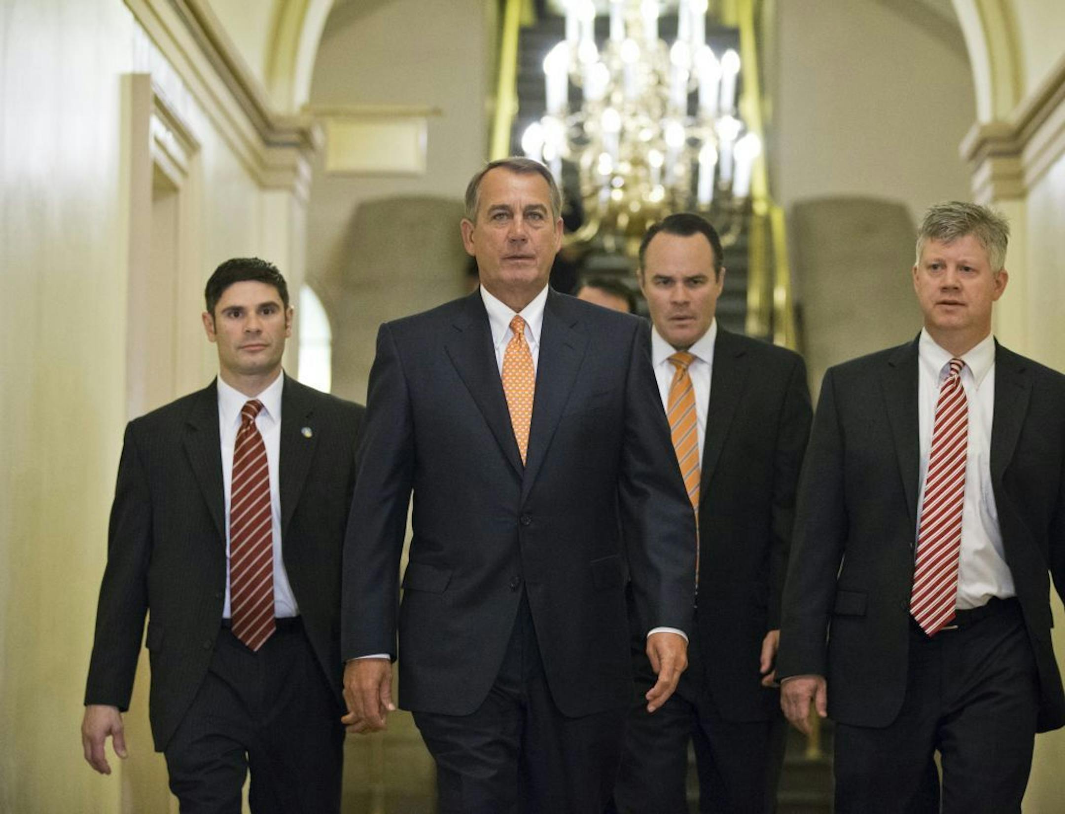 House Speaker John Boehner of Ohio, center, walks to his meeting with President Barack Obama on Capitol Hill in Washington, Wednesday, March 13, 2013.