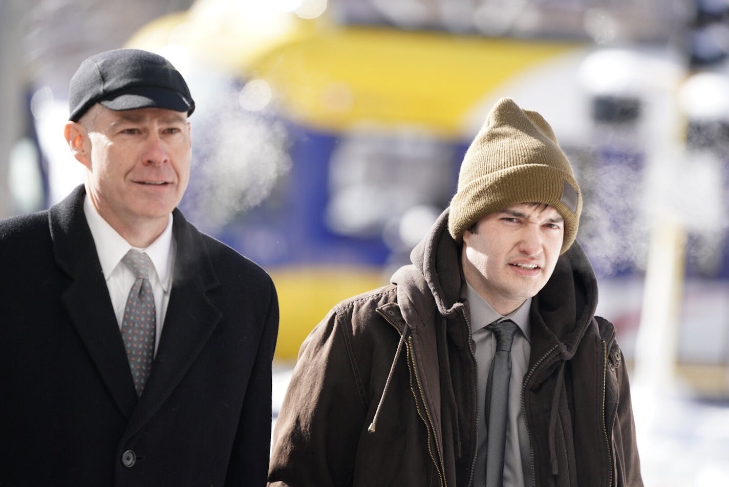 Kenneth Lilly, right, charged with shooting a school bus driver on Interstate 35W, made his first court appearance Friday. At left is lawyer Thomas Plunkett.