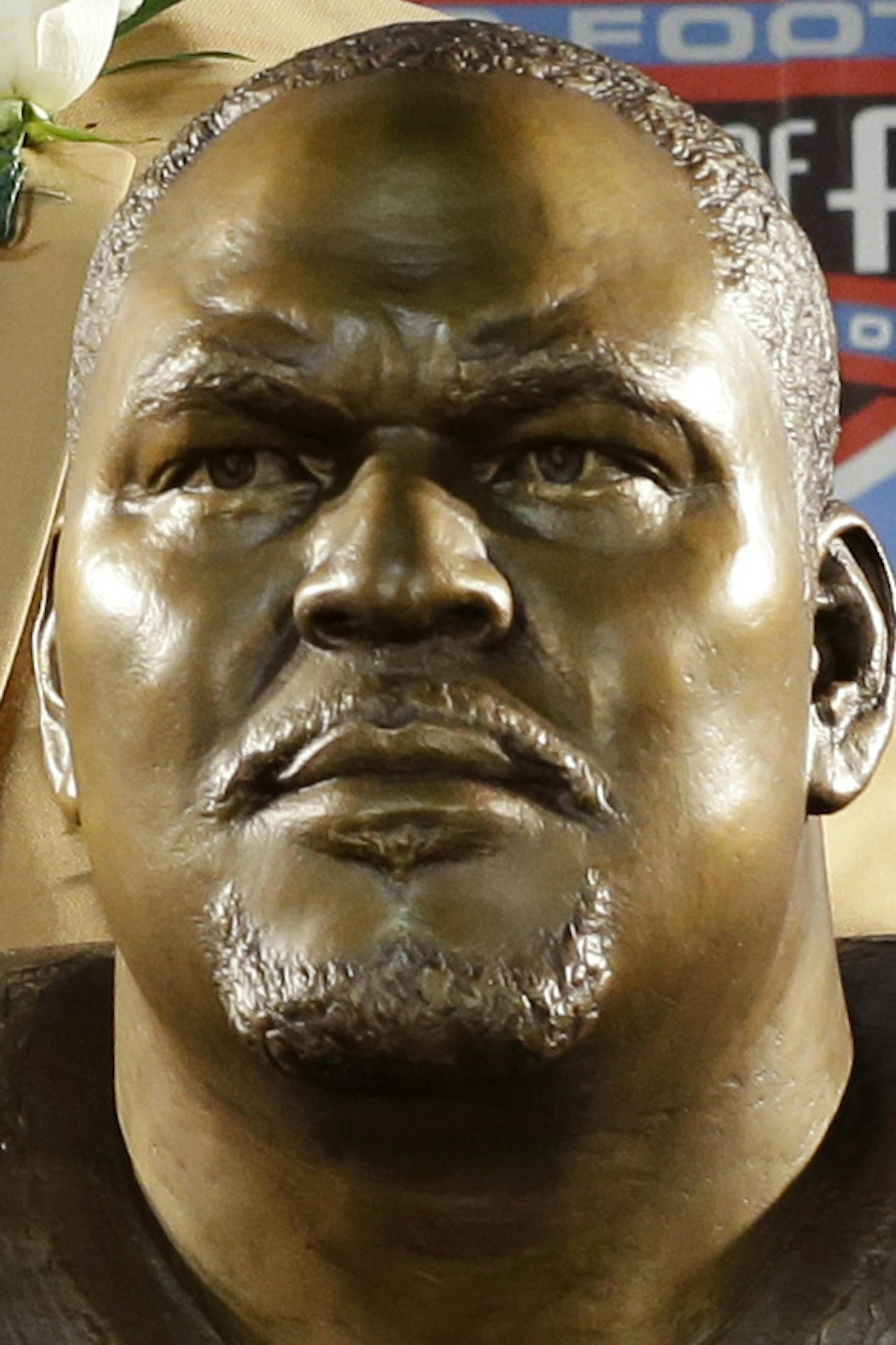 Hall of Fame inductee Walter Jones poses with his bust during the 2014 Pro Football Hall of Fame Enshrinement Ceremony at the Pro Football Hall of Fame Saturday, Aug. 2, 2014, in Canton, Ohio. (AP Photo/Tony Dejak)