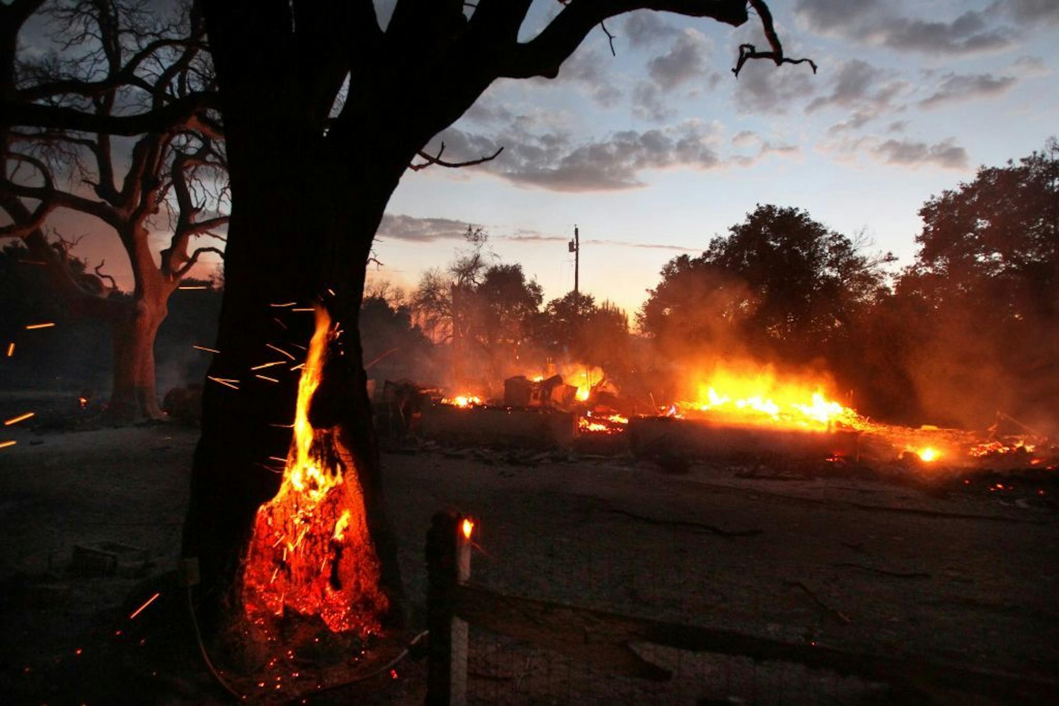 In a Sunday, Sept. 23, 2012 photo, a home burns on Tierra Del Sol Road near the community of Boulevard, Calif. Evacuations were ordered in the area because of a brush fire. No injuries were reported. (AP Photo/UT San Diego, Charlie Neuman) SAN DIEGO COUNTY OUT; NO SALES; COMMERCIAL INTERNET OUT; FOREIGN OUT