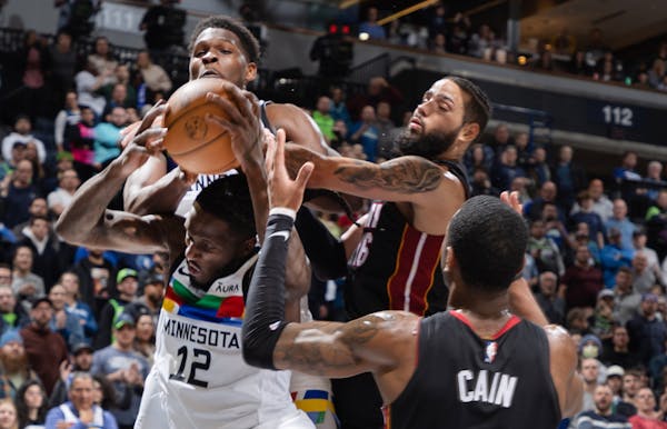 Taurean Prince (12) and Anthony Edwards (1) of the Minnesota Timberwolves grab a rebound in the fourth quarter Monday, November 21, 2022, at Target Ce