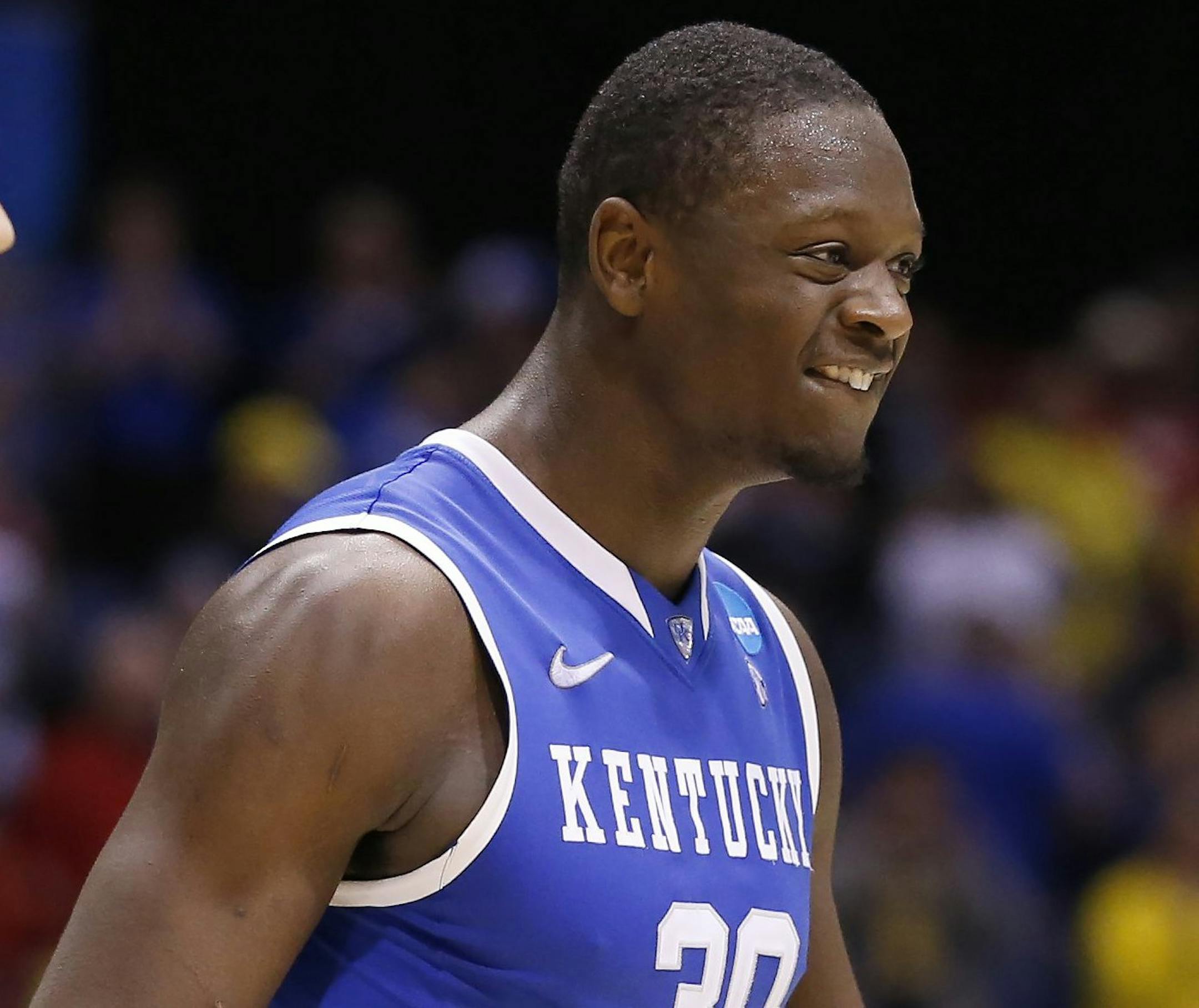 Kentucky Wildcats forward Julius Randle (30) celebrates the win as Louisville Cardinals guard/forward Luke Hancock (11) looks on. The Kentucky Wildcats defeated Louisville 74-69 in the NCAA Tournament's Midwest Region semifinal at Lucas Oil Stadium in Indianapolis on Friday, March 28, 2014. (Sam Riche/MCT) ORG XMIT: 1151010