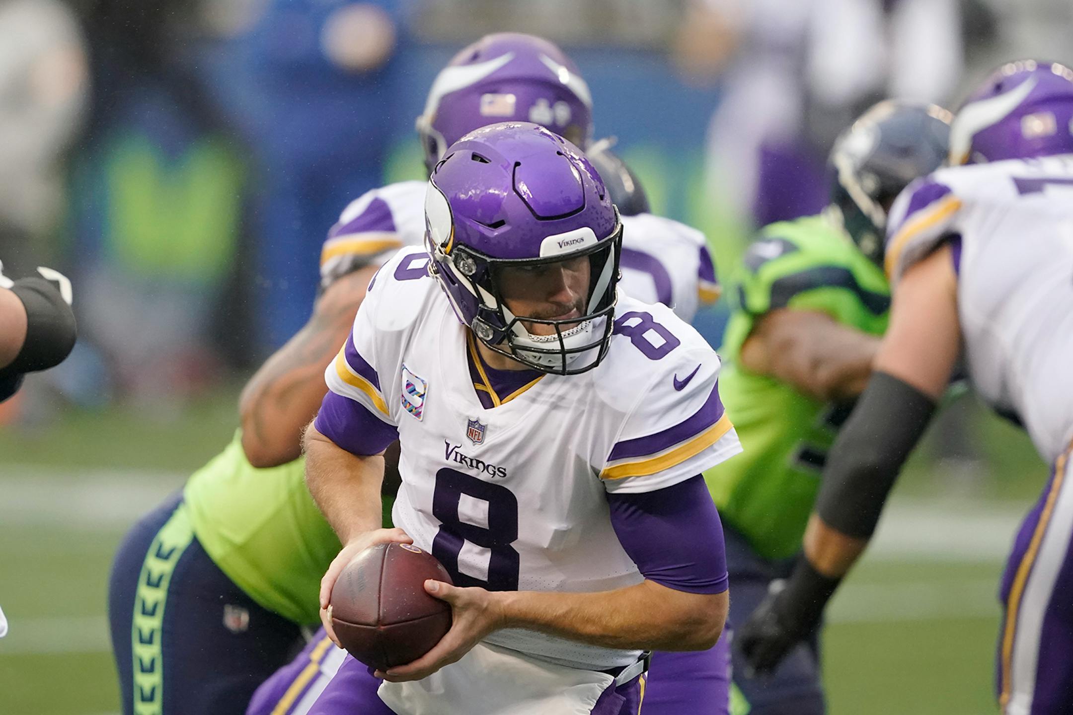 Minnesota Vikings quarterback Kirk Cousins turns to make a play against the Seattle Seahawks during the first half of an NFL football game, Sunday, Oct. 11, 2020, in Seattle. (AP Photo/Ted S. Warren)