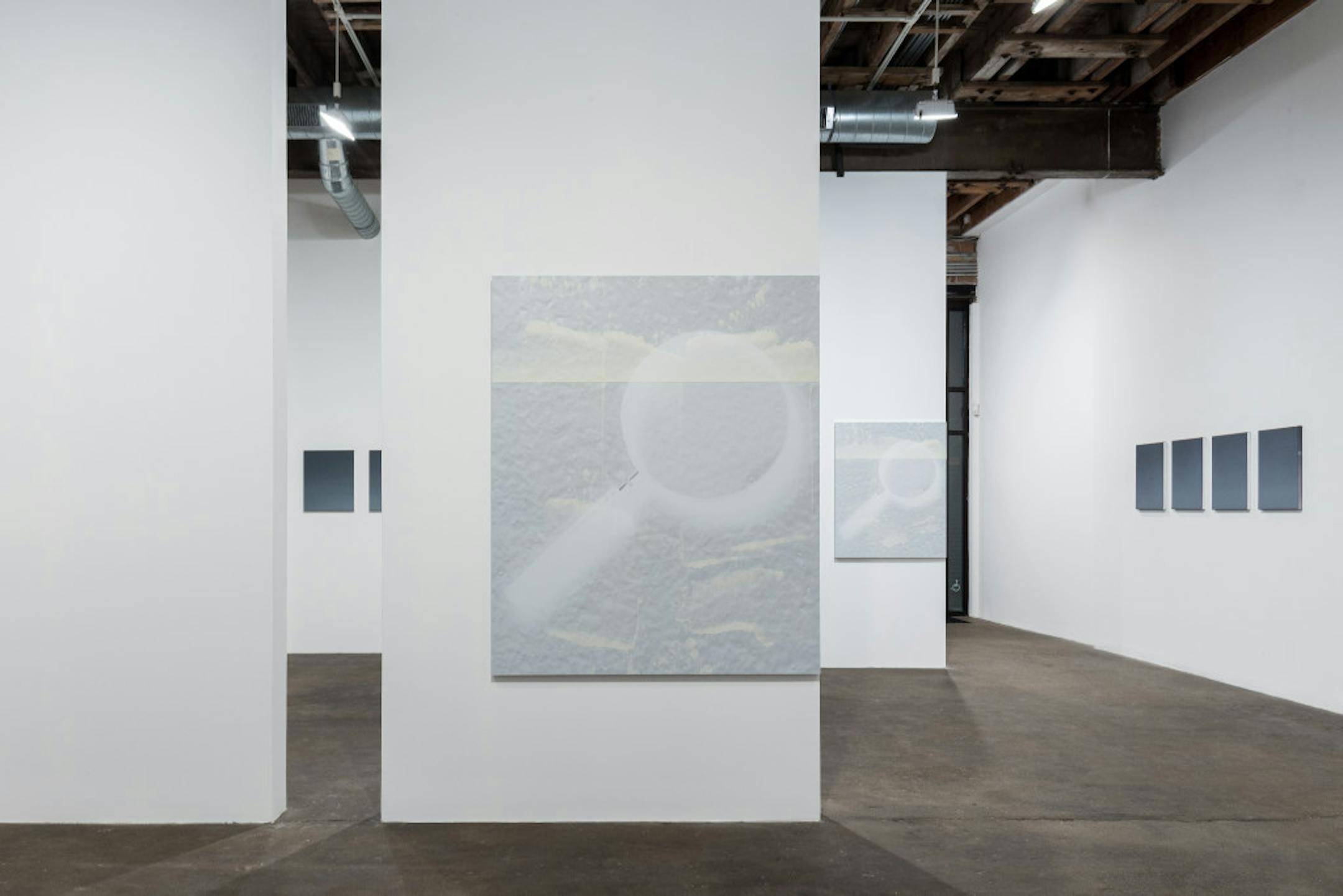 Paintings of magnifying glasses on aluminum panels figure in Nathan Hylden's exhibition "Nearing on to Do" at Midway Contemporary Art.