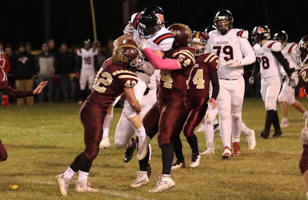 Lester Prairie linebackers Jace Cacka (42) and Noah Behning wrapped up a runner during a victory over Mayer Lutheran.