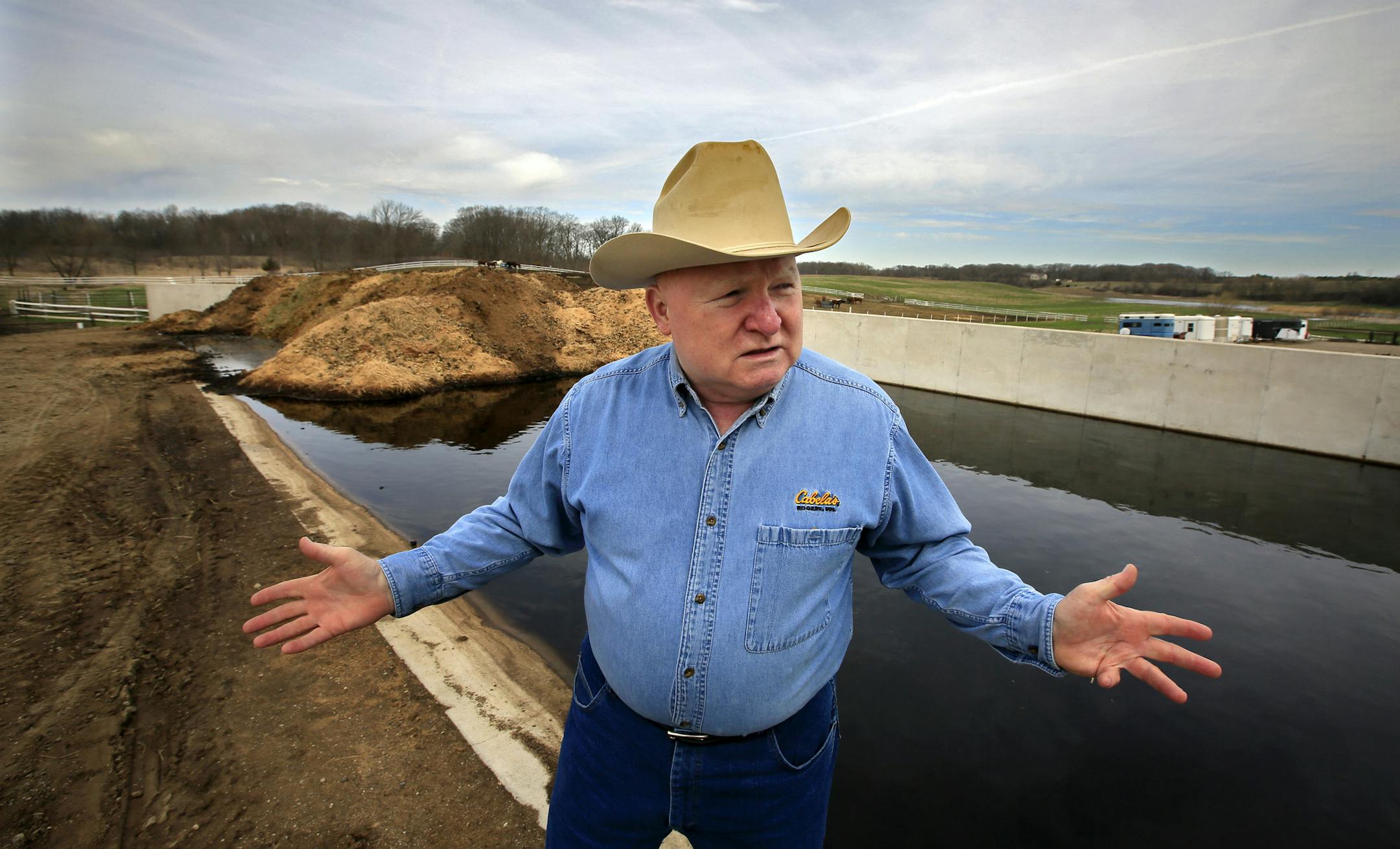 Larry MESSERLI (not Nesserly) points out the steps they've taken at the Shriner horse farm to reduce manure runoff into Lake Rebecca, including this concrete manure containment pit. A decade ago Lake Rebecca was so polluted with algae that fish died each July and Three Rivers Park District curtained off the public swimming area to keep the slime at bay. Now the west metro lake is well on the way to a remarkable comeback, thanks to several improvements and an infusion of money. ] BRIAN PETERSON &