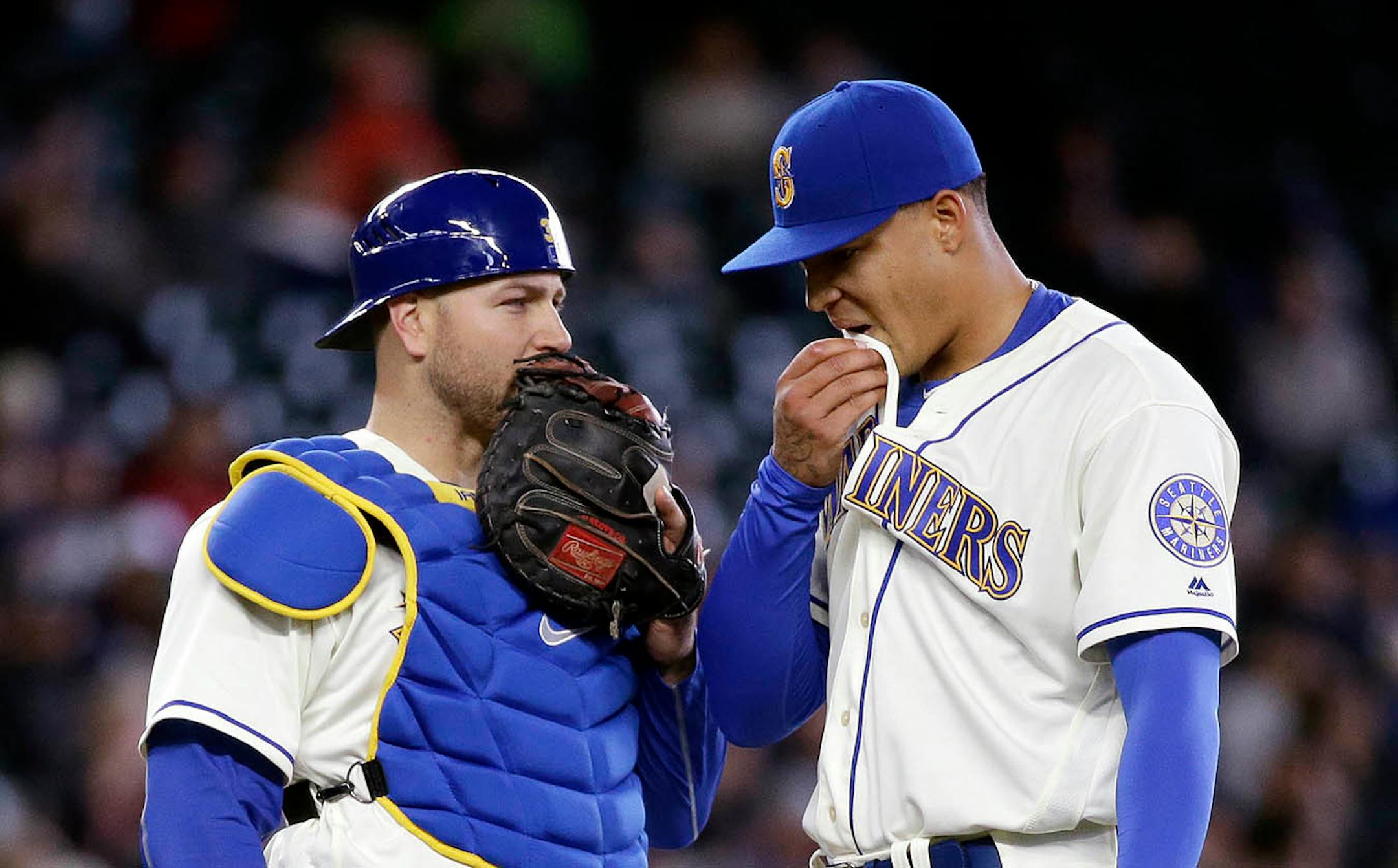 Seattle Mariners catcher Chris Iannetta, left, and starting pitcher Taijuan Walker talk after Walker gave up two home runs to the Minnesota Twins in the fourth inning of a baseball game, Sunday, May 29, 2016, in Seattle.