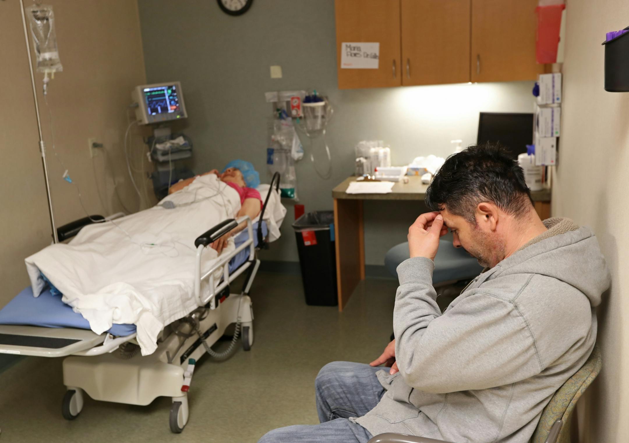 William Recinos Flores waited with his mother Maria Flores DeCalles in a pre-operation space before she underwent cataract surgery.