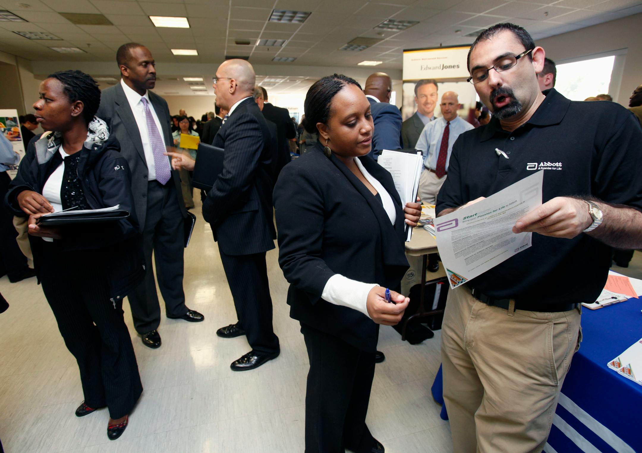 George Kaliviotis, right, from Abbott Labs, speaks with Lisa McCarthy during a jobs fair sponsored in Boston, Friday, Oct. 7, 2011.