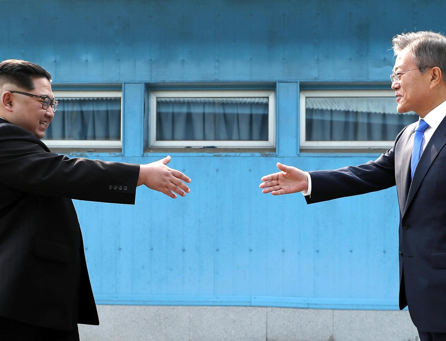 North Korean leader Kim Jong Un, left, prepares to shake hands with South Korean President Moon Jae-in over the military demarcation line at the border village of Panmunjom in Demilitarized Zone Friday, April 27, 2018. Their discussions will be expected to focus on whether the North can be persuaded to give up its nuclear bombs. (Korea Summit Press Pool via AP) ORG XMIT: XAHN157