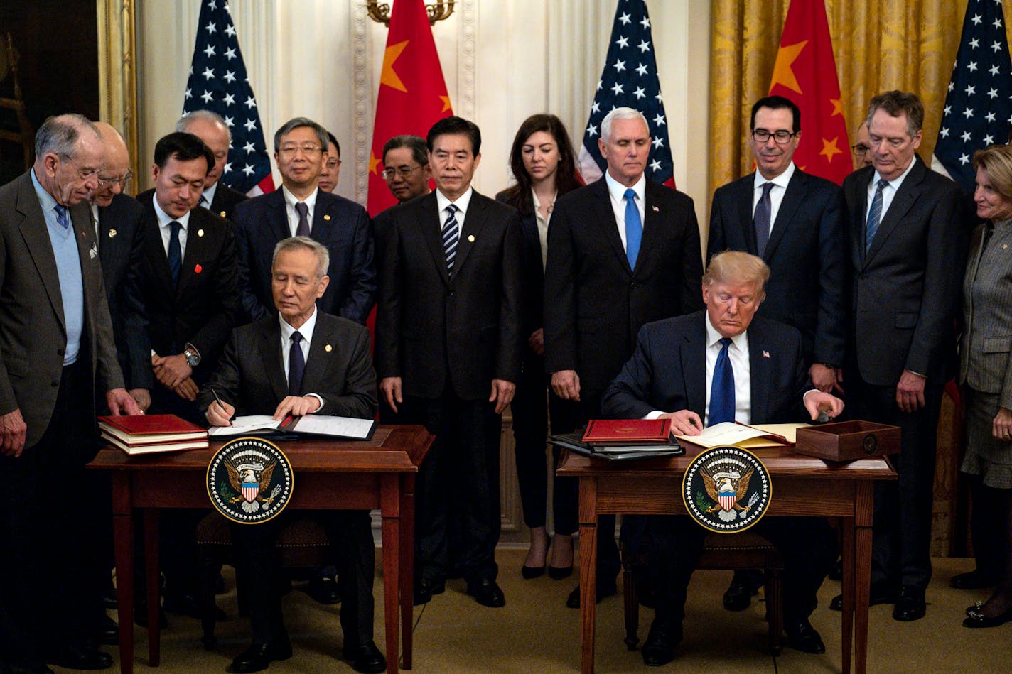 FILE — President Donald Trump, right, and Chinese Vice Premier Liu He sign an initial trade agreement in the White House in Washington, Jan. 15, 2020. Last year's U.S.-China trade deal could set the rules for global commerce for years to come, leaving the door open to lavish Chinese subsidies and unilateral American tariffs. (Pete Marovich/The New York Times)