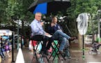 Columnist Lee Schafer, left, and Minneapolis Fed President Neel Kashkari in the rain at the Minnesota State Fair on Tuesday.
