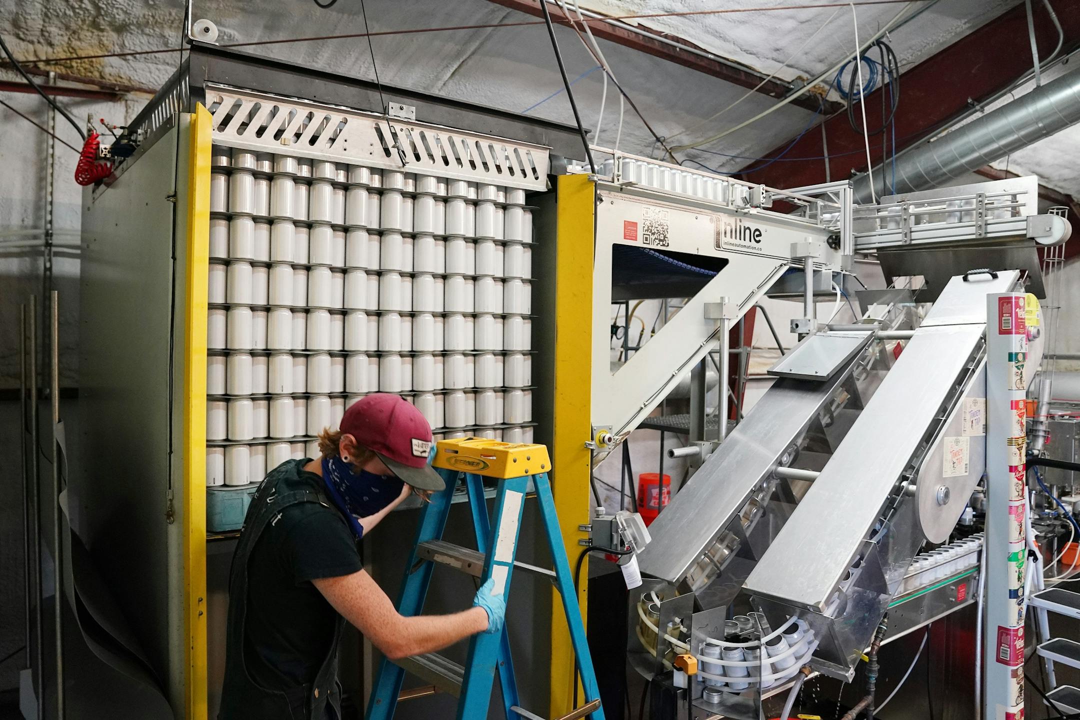 Mark Hines loaded blank cans into the canning line for Sociable Cider Werks' Squoze Hard Seltzer Thursday morning in northeast Minneapolis.