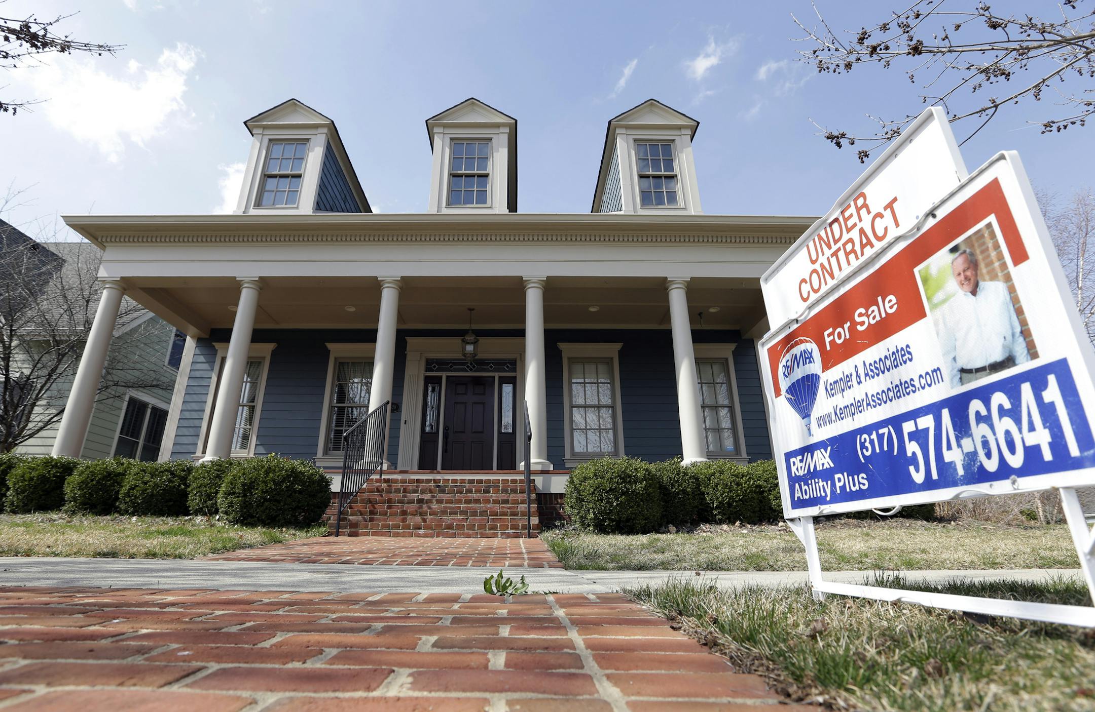 In this Tuesday, April 9, 2013 photo, an "Under Contract" sign is posted outside a home in Carmel, Ind. Private data provider CoreLogic issues its report on home prices for April, on Tuesday, June 4, 2013. (AP Photo/Michael Conroy) ORG XMIT: MIN2013060417002688