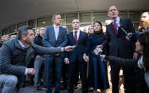 Trooper Ryan Londregan, center in maroon tie, stood hand-in-hand with his wife surrounded by security, his lawyers and dozens of supporters, including