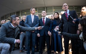 Trooper Ryan Londregan, center stood hand-in-hand with his wife surrounded by security, his lawyers and dozens of supporters after his first court app