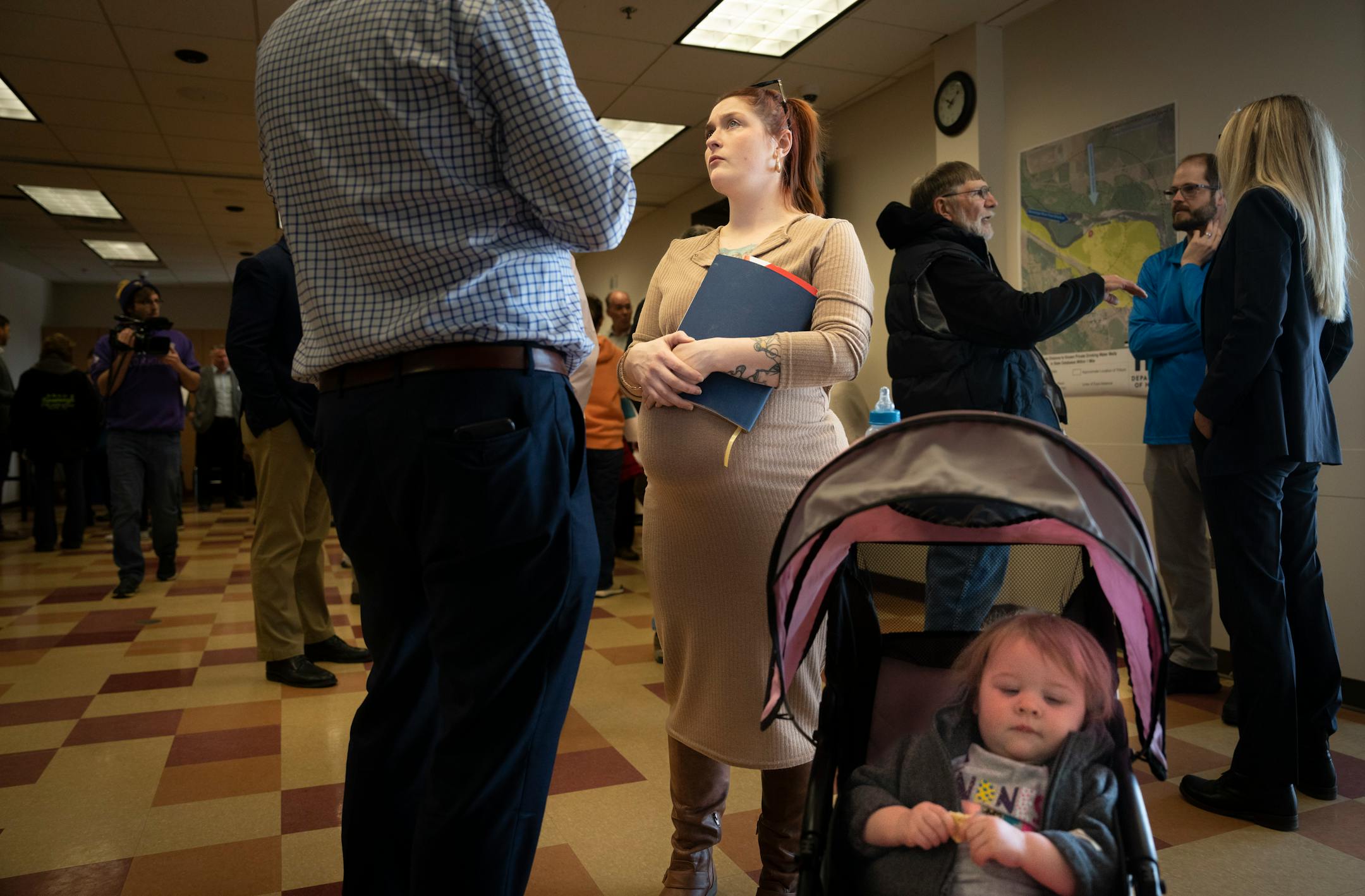 Megan Sunburn, who is 6 months pregnant, came with her daughter Eivor and a notebook full of questions for Xcel Energy and government representatives at a community meeting after two reported leaks at the nearby nuclear power plant. She is talking with MPCA rep. Darin Broton.