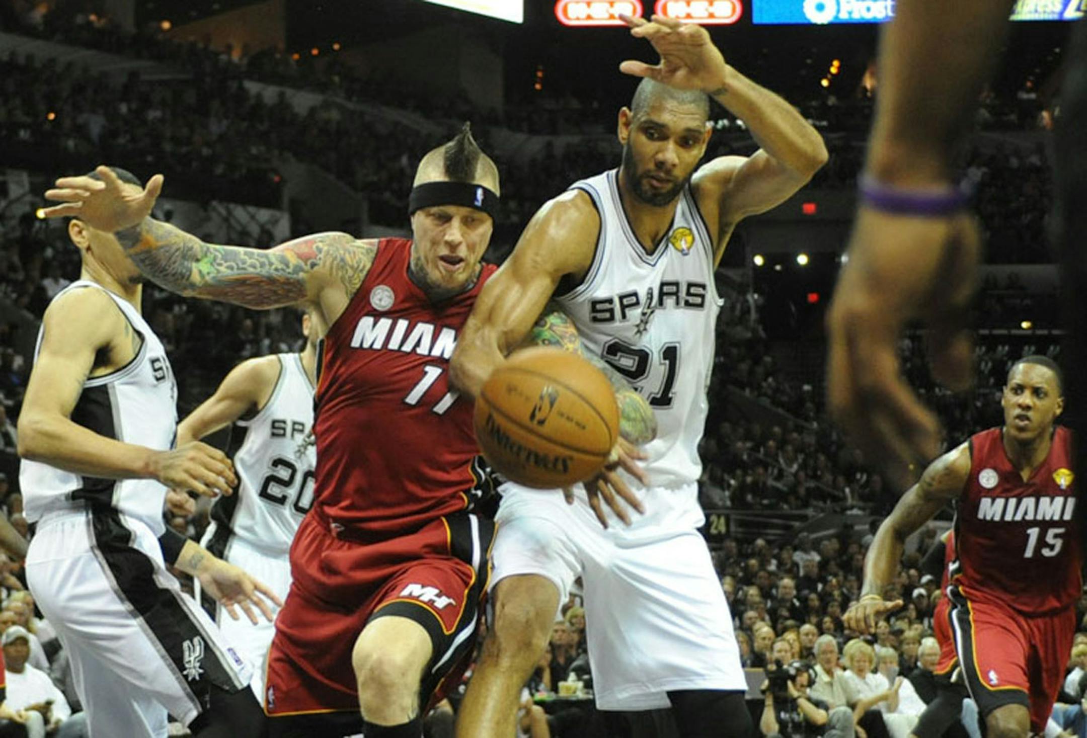 Chris Andersen of the Heat and the Spurs' Tim Duncan fought for a loose ball during the first quarter in Game 3 of the NBA Finals on Tuesday.
