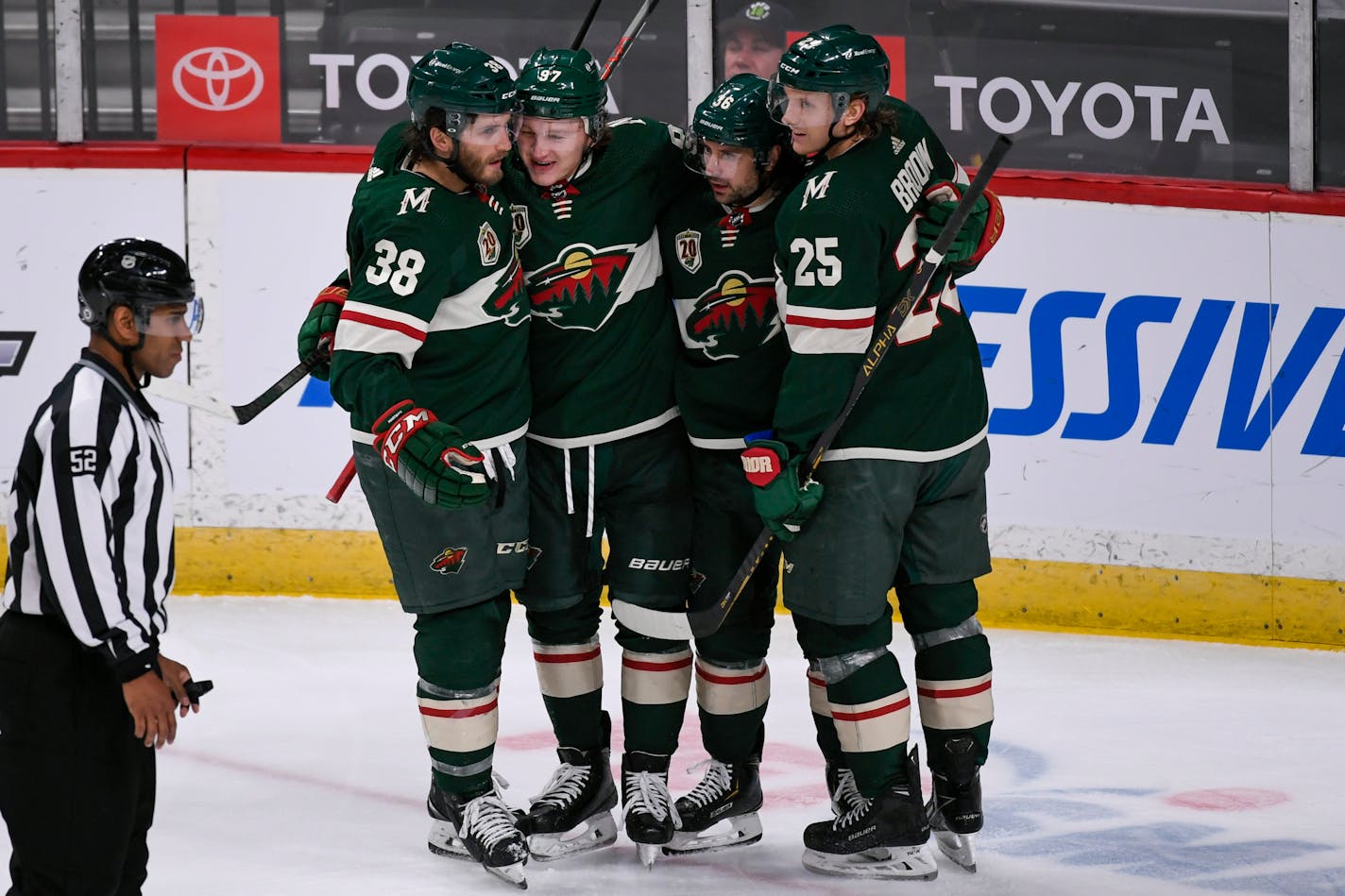 Minnesota Wild right wing Ryan Hartman (38), left wing Kirill Kaprizov (97), right wing Mats Zuccarello (36) and defenseman Jonas Brodin (25) celebrate after Zuccarello scored during the second period of an NHL hockey game against the St. Louis Blues, Saturday, May 1, 2021, in St. Paul, Minn. (AP Photo/Craig Lassig)