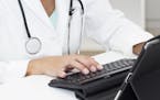 iStockphoto.com
Close-up of female doctors hands typing on Digital Tablet.