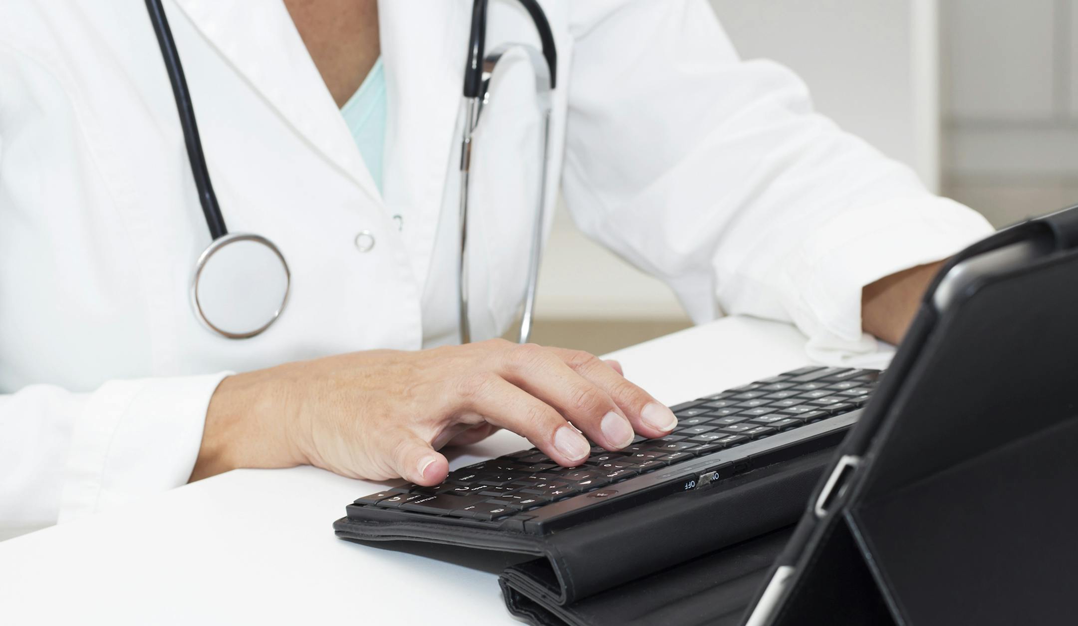 iStockphoto.com
Close-up of female doctors hands typing on Digital Tablet.
