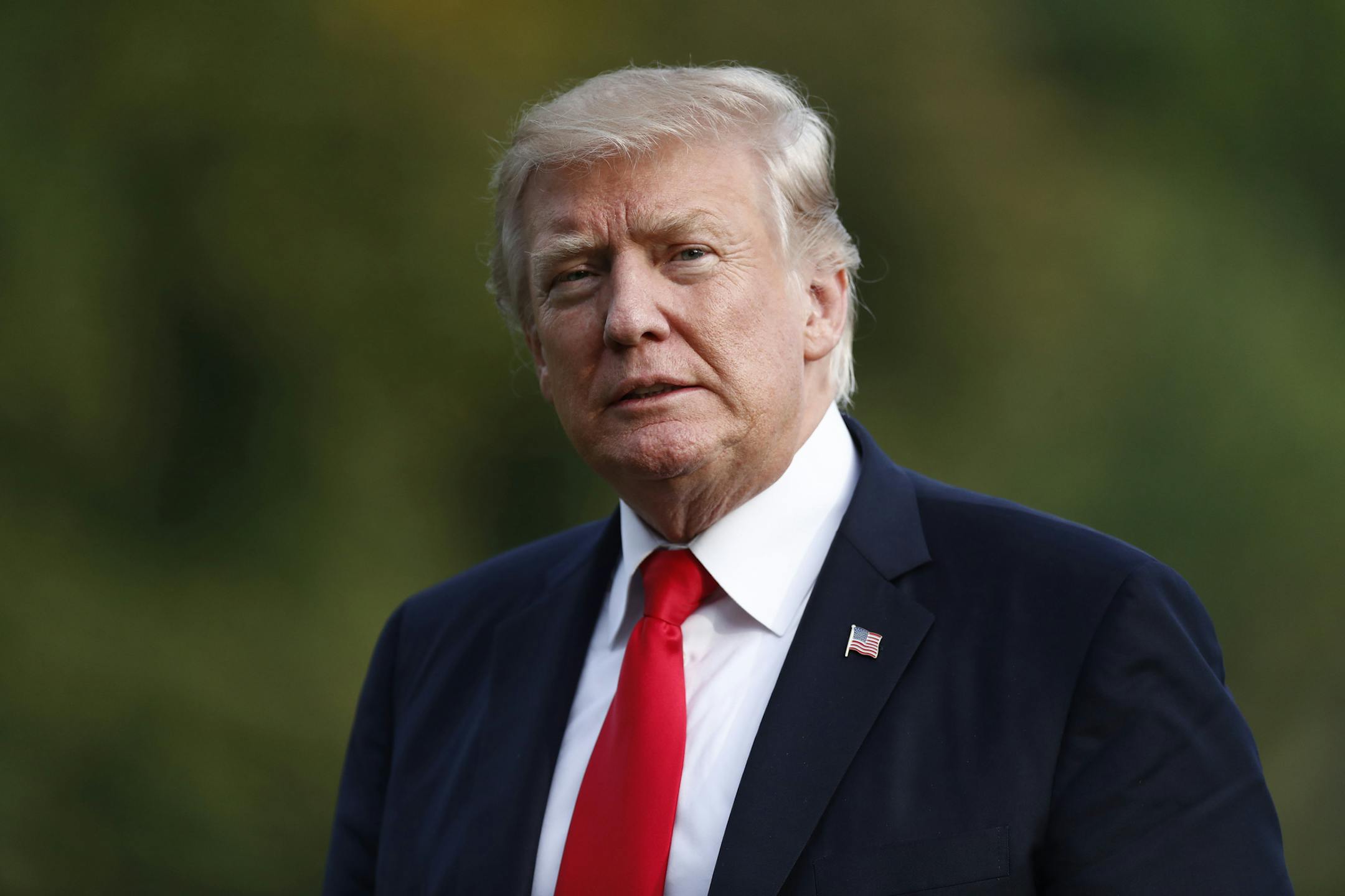 FILE - In this Wednesday, Aug. 30, 2017, file photo, President Donald Trump walks from Marine One across the South Lawn to the White House in Washington.