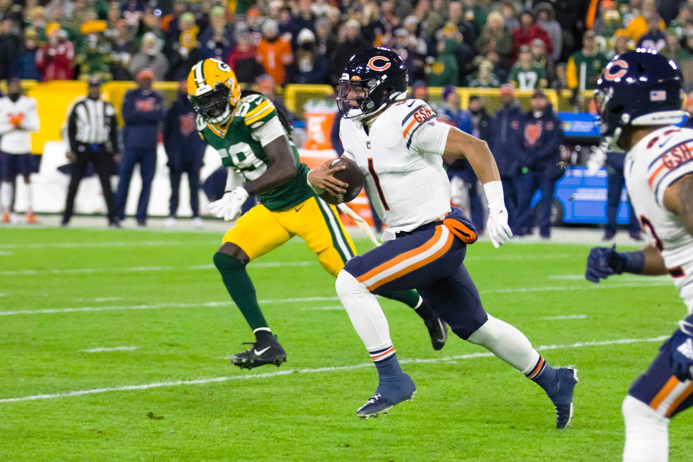 Chicago Bears quarterback Justin Fields (1) rushes against the Green Bay Packers during an NFL football game on Sunday, Dec. 12, 2021, in Green Bay, Wis. (Adam Niemi/The Daily Mining Gazette via AP)