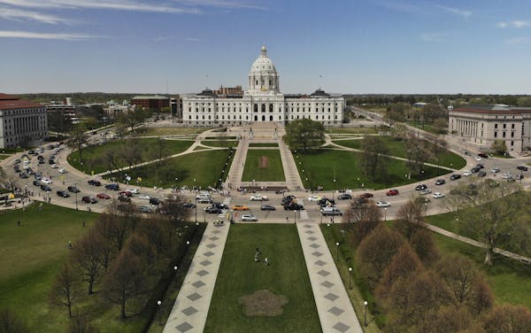 Vehicles circled the Minnesota State Capitol, covered with flags and signs, during Saturday's protest against Gov. Tim Walz's "Stay Home MN" executive