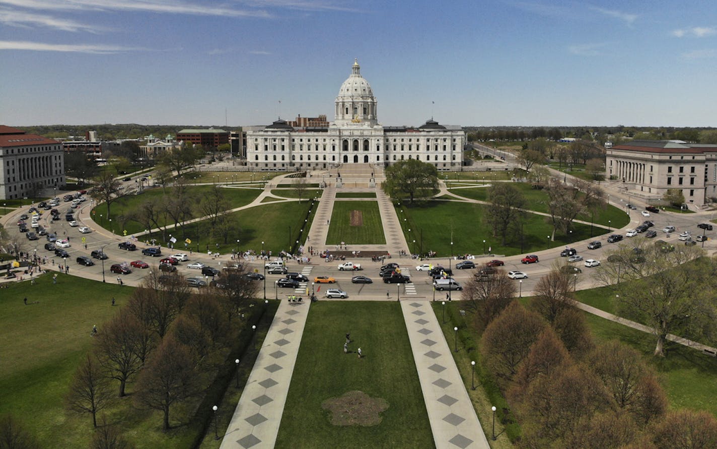 Vehicles circled the Minnesota State Capitol, covered with flags and signs, during Saturday's protest against Gov. Tim Walz's "Stay Home MN" executive orders meant to slow the spread of COVID-19 ] aaron.lavinsky@startribune.com Protesters organized by the Minnesota Gun Rights advocacy group staged a drive-by protest calling for an end to Gov. Tim Walz's "Stay Home MN" executive orders meant to slow the spread of COVID-19 Saturday, May 2, 2020 at the State Capitol in St. Paul, Minn.