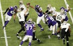 New Orleans Saints quarterback Drew Brees (9) was surrounded by purple Vikings jerseys while throwing under pressure in the second quarter of Sunday's
