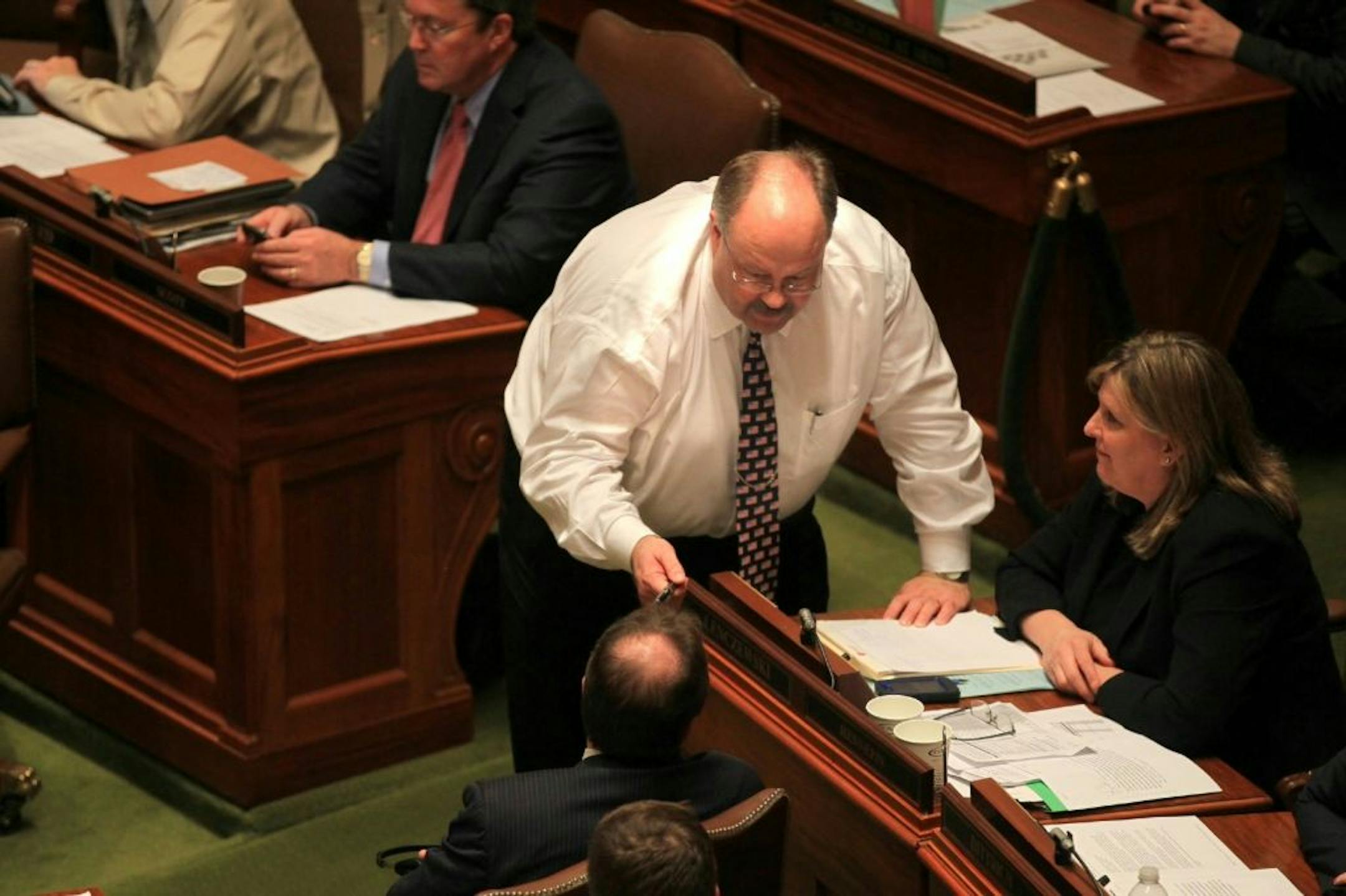 Republican state Rep. Greg Davids, author of the omnibus tax bill, chatted with DFL Reps. Paul Marquart and Ann Lenczewski during discussion of the bill Wednesday at the State Capitol.