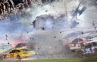 Austin Dillon (3) goes airborne and hits the catch fence as he was involved in a multi-car crash on the final lap of the NASCAR Sprint Cup series auto