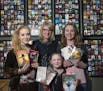 Elisabeth Ansley, middle, calls on daughters Chaeli, 20, Niamh, 8, and Georgia, 17, to model for many of her pop-fiction paperback shots.