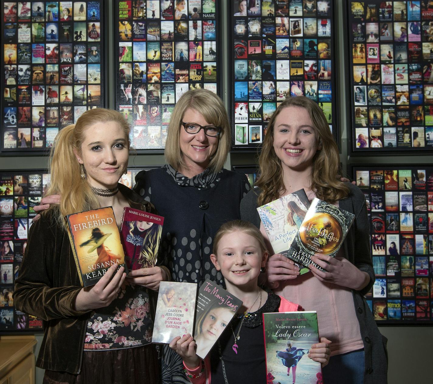 Elisabeth Ansley, middle, calls on daughters Chaeli, 20, Niamh, 8, and Georgia, 17, to model for many of her pop-fiction paperback shots.