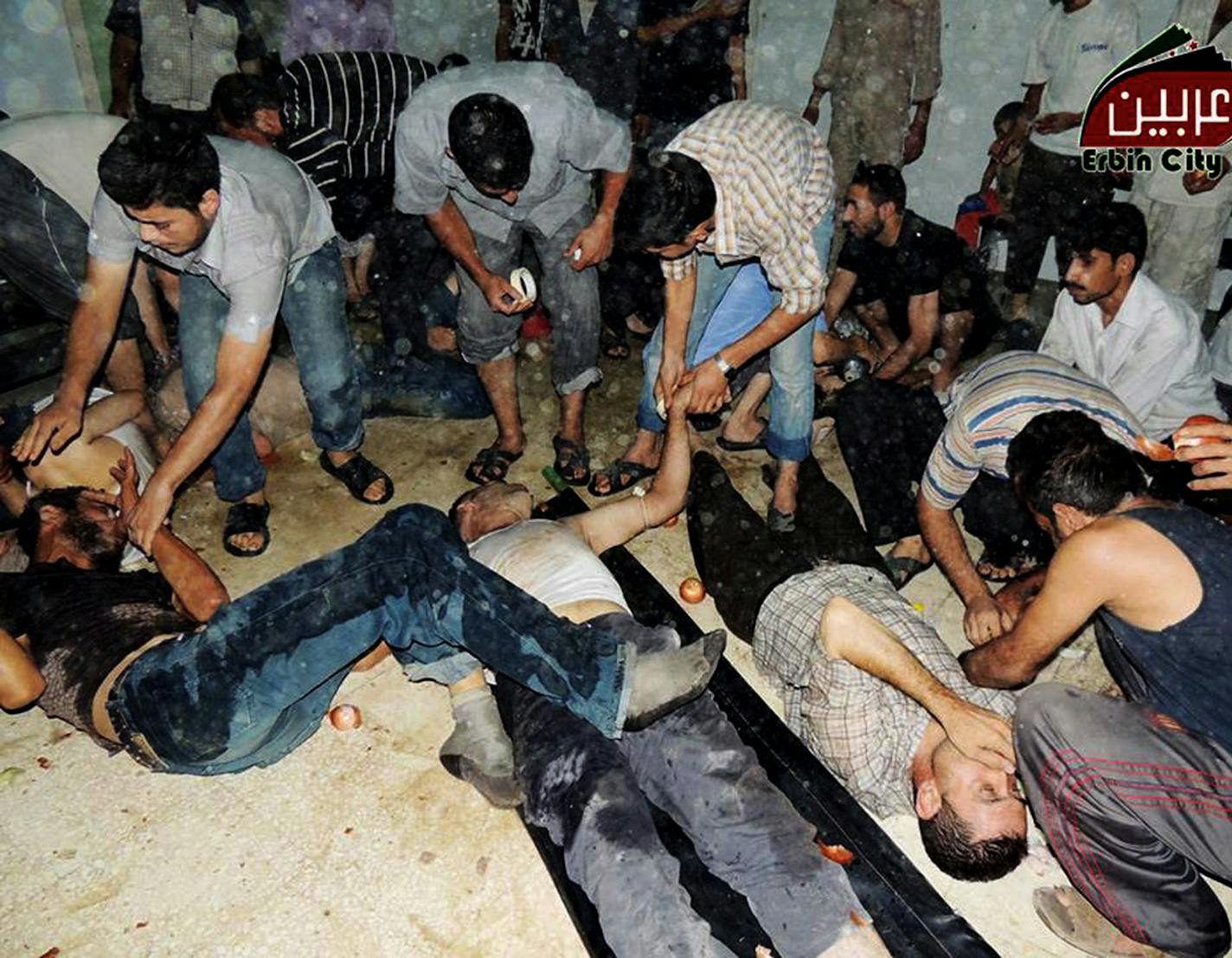 EDS NOTE: GRAPHIC CONTENT - This citizen journalism image provided by the Local Committee of Arbeen which has been authenticated based on its contents and other AP reporting, shows Syrian citizens receiving treatment after an alleged poisonous gas attack fired by regime forces, according to activists in Arbeen town, Damascus, Syria, Wednesday, Aug. 21, 2013. Syrian regime forces fired intense artillery and rocket barrages Wednesday on the eastern suburbs of the capital Damascus, in what two pro-