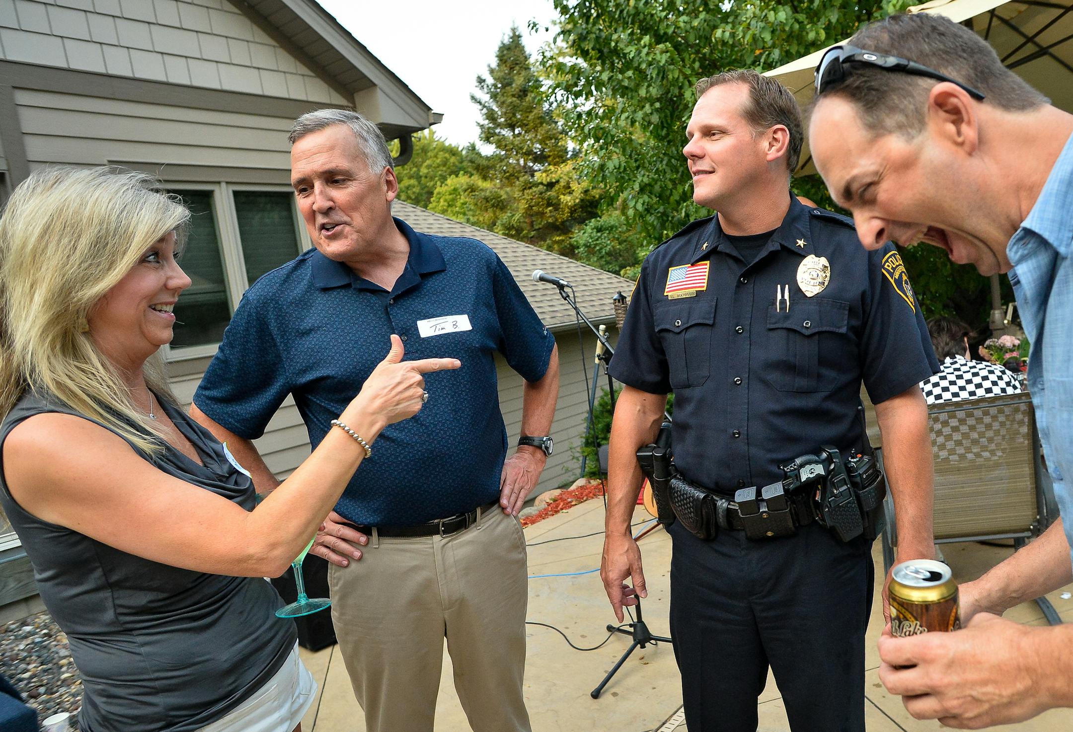 Sharon Dewitz, left, and Tom Dewitz, right, joked with Minnetonka City Council Member Tim Bergstedt and Police Chief Scott Boerboom at their National Night Out party.