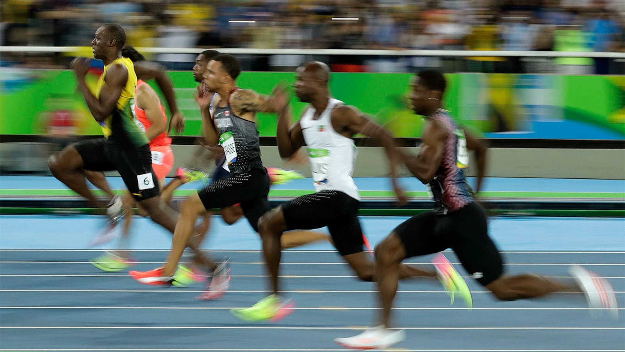 Jamaica's Usain Bolt, left, takes the lead in a men's 100-meter semifinal during the athletics competitions of the 2016 Summer Olympics at the Olympic stadium in Rio de Janeiro, Brazil, Sunday, Aug. 14, 2016.