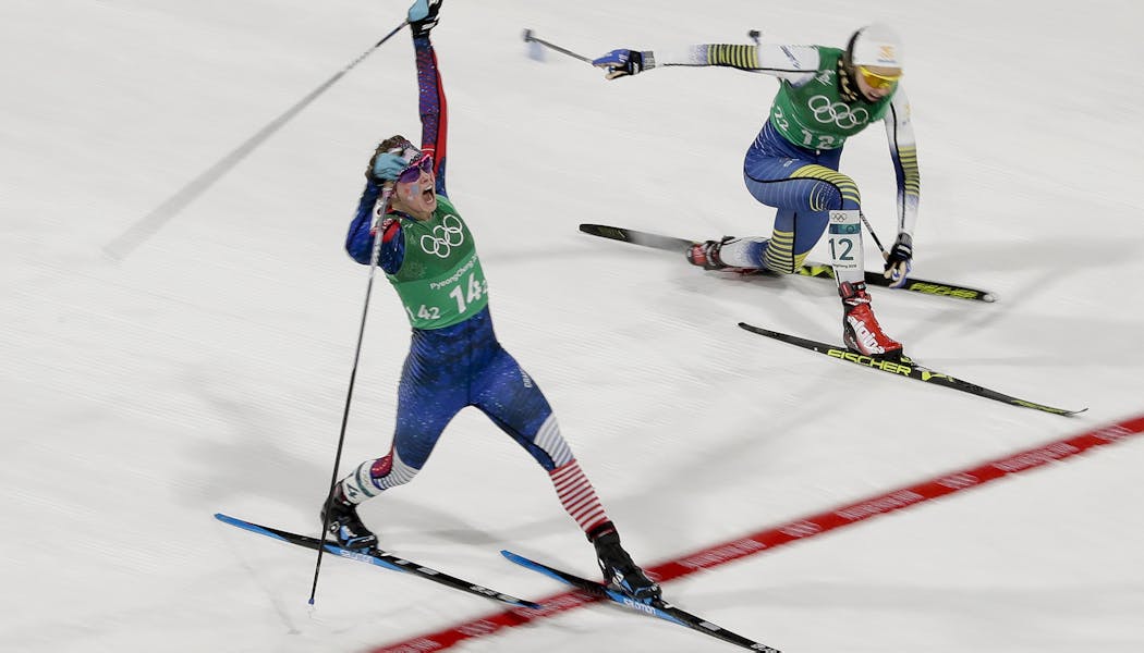 Jessica Diggins, left, of the United States, celebrates after winning the gold medal past Stina Nilsson, of Sweden at the 2018 Winter Olympics in Pyeongchang, South Korea.