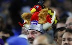 A Minnesota Vikings fan wears a turkey on his viking helmet during an NFL football game against the Detroit Lions in Detroit, Thursday, Nov. 24, 2016.