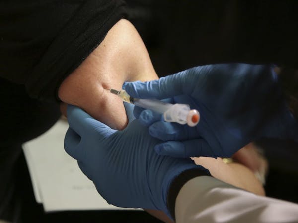 FILE - In this March 27, 2019, file photo, a woman receives a measles, mumps and rubella vaccine at the Rockland County Health Department in Pomona, N