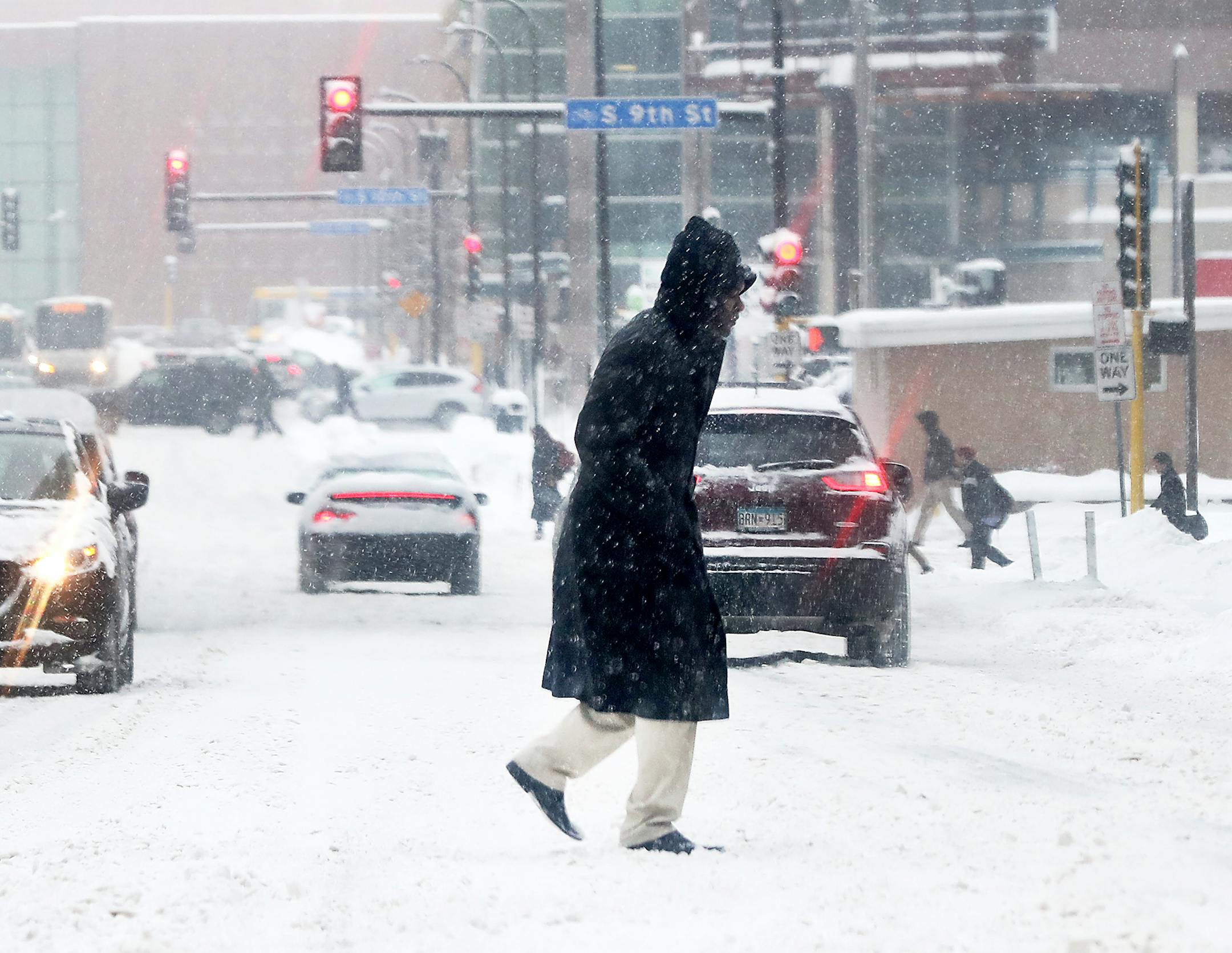 A pedestrians makes his way across Third Ave. S.in the snow Tuesday, Feb. 12, 2019, in Minneapolis, MN.] DAVID JOLES &#x2022;david.joles@startribune.com Latest round of snow**,cq