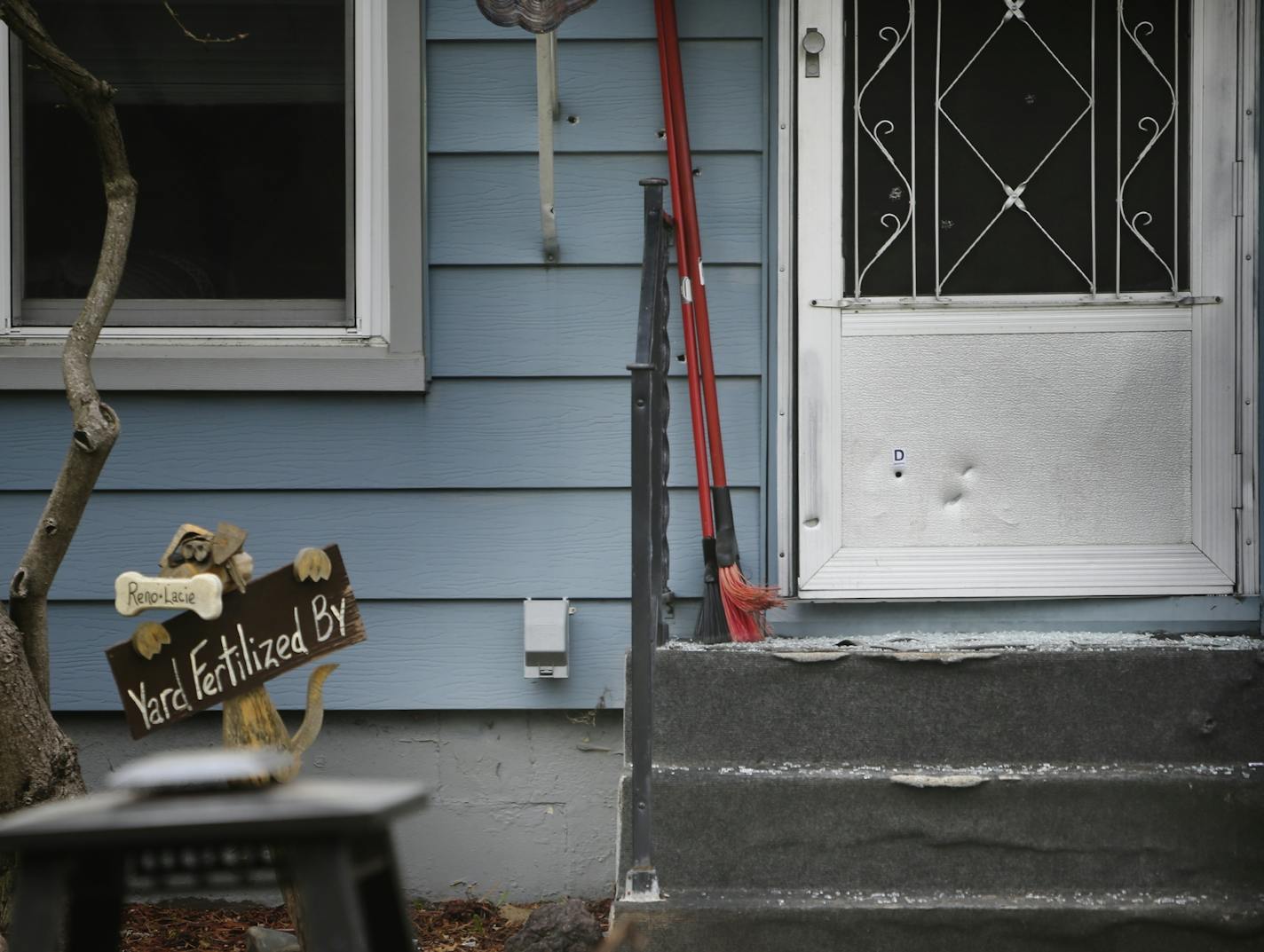 An ongoing dispute between neighbors over feeding deer erupted in gunfire Monday night in New Brighton. One man is dead, another victim is hospitalize. Here, several bullet holes are visible in the side of the victim's house as well as the door Tuesday, May 6, In New Brighton, MN.