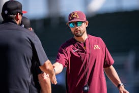 Gophers baseball coach Ty McDevitt shakes hands during a game against Northeastern on Feb. 24 in Fort Myers, Fla.