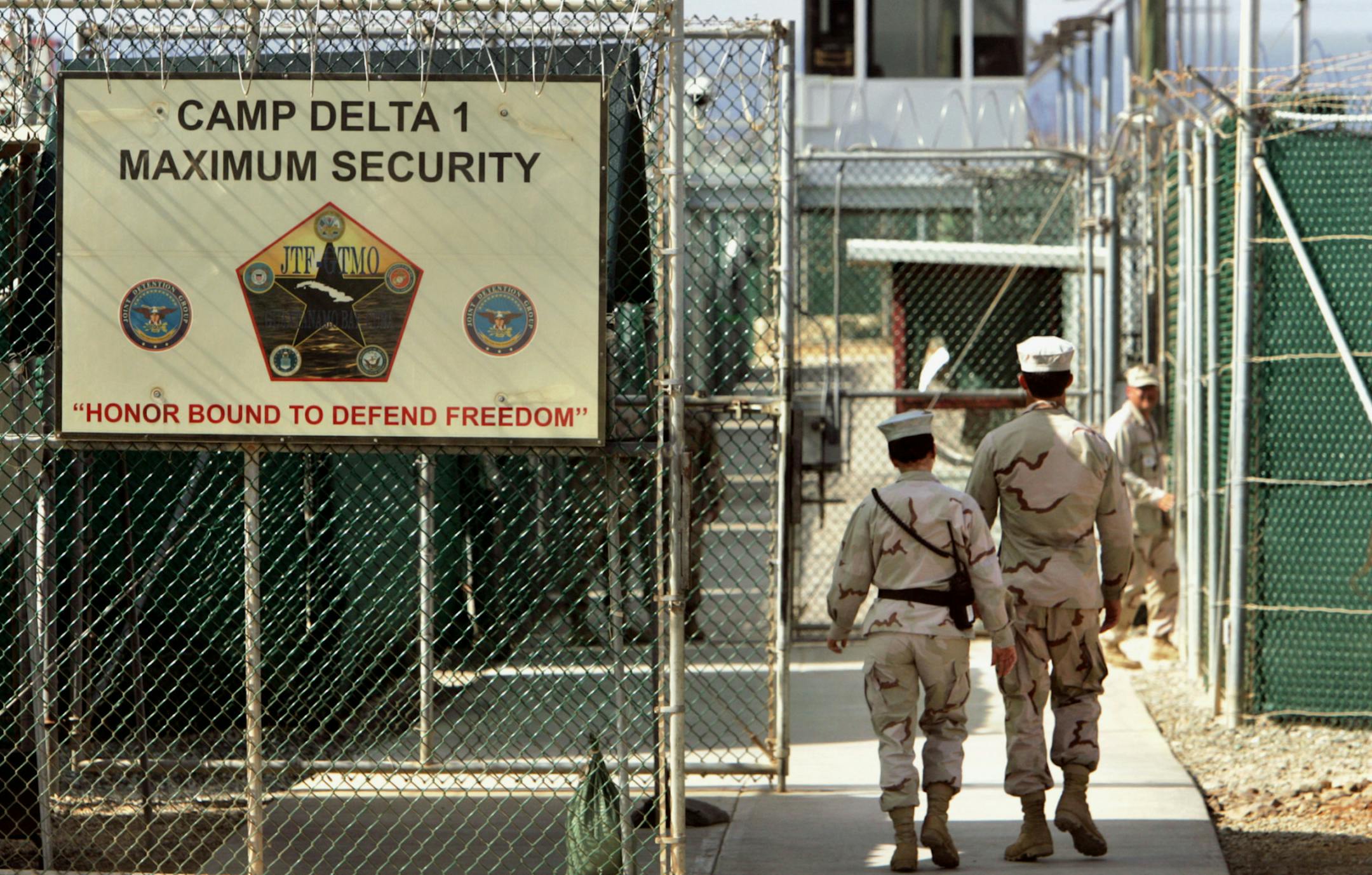 FILE - In this June 27, 2006 file photo, reviewed by a Defense Department, U.S. military guards walk within Camp Delta military-run prison, at the Guantanamo Bay U.S. Naval Base, Cuba. A federal appeals court expressed concerns on Thursday, Sept. 8, 2016, about the prospect of ordering the Obama administration to release graphic videos of a former Guantanamo Bay inmate being force-fed during a hunger strike. (AP Photo/Brennan Linsley, File) ORG XMIT: WX110