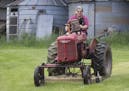 Lori Guenther mowed the lawn with her dog on Wednesday, June 24, 2015, in Waubun, Minn. Guenther found her father in a field after he fell asleep whil