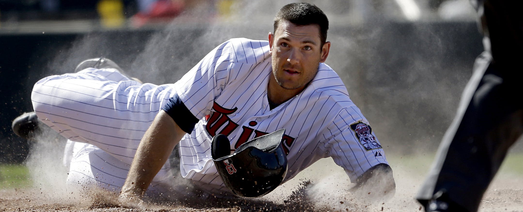 Minnesota Twins' Jeff Clement looks up as he loses his helmet after getting tagged out on a slide at home plate by Boston Red Sox catcher Jarrod Saltalamacchia in the fourth inning of a spring training exhibition baseball game, Thursday, March 7, 2013, in Fort Myers, Fla. (AP Photo/David Goldman)