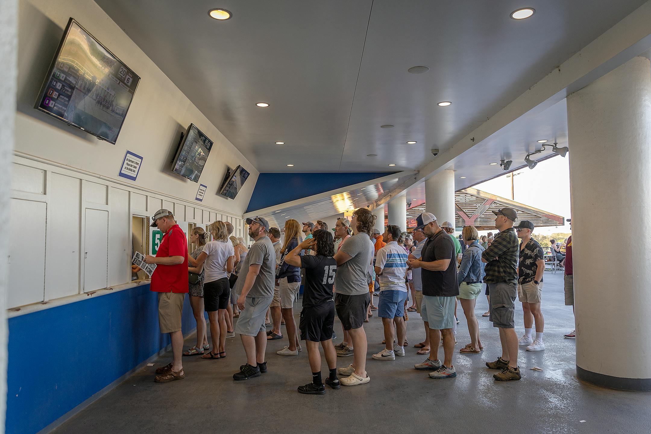 Race line to place their bets on opening night at Canterbury Park.