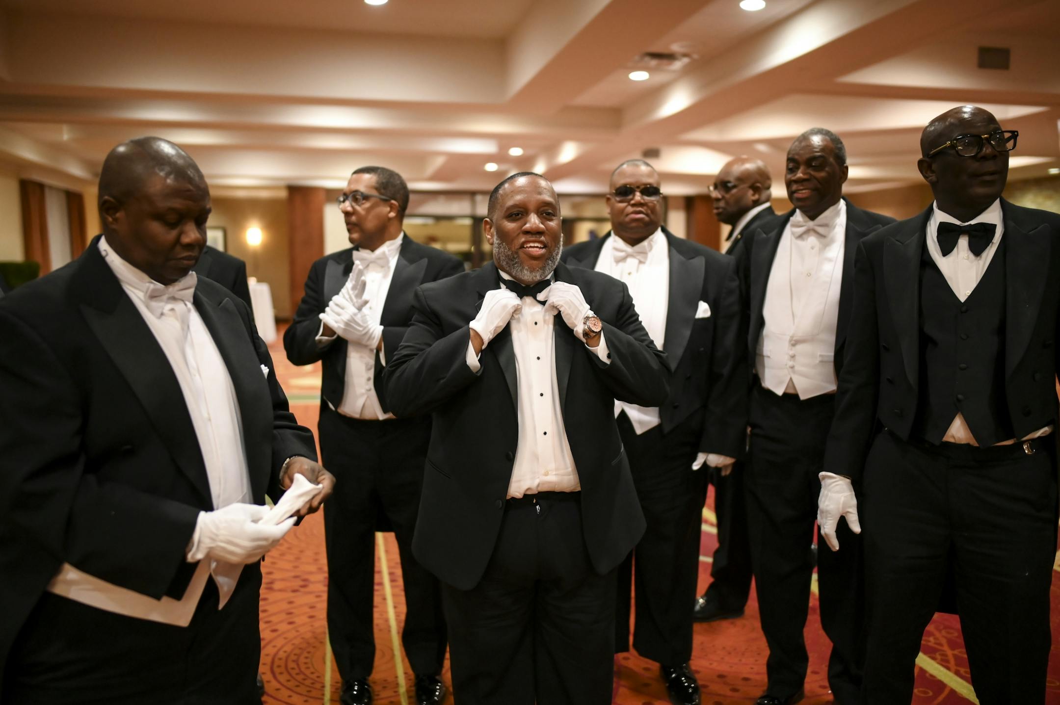 Parents and senior escorts, including the Rev. Ovester Armstrong Jr., of Rosemount, center, prepared to walk into the cotillion ball with their debutantes Saturday night. His daughter, Zharia Armstrong, is a junior honor roll student at Eastview.